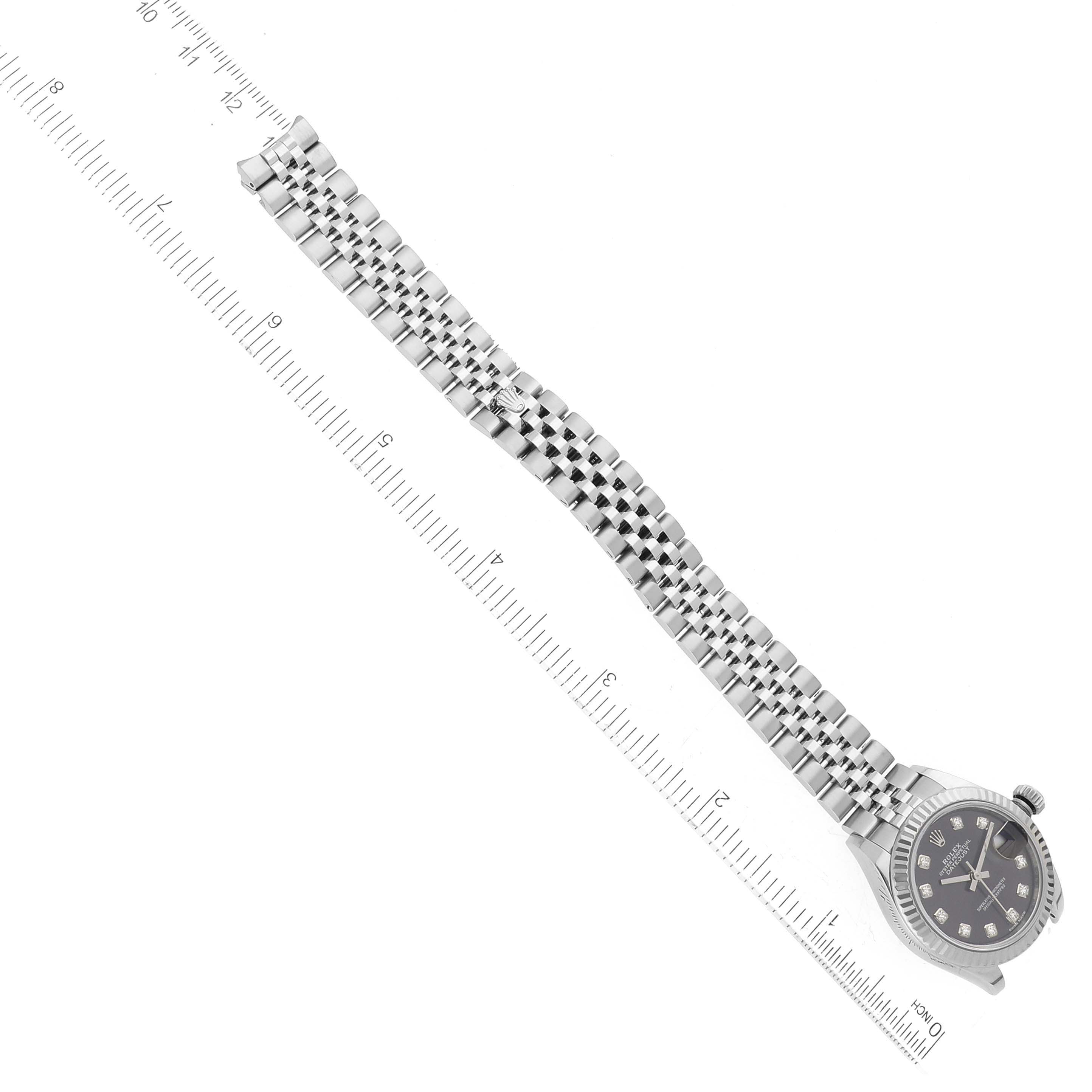 The image shows a top view of the Rolex Datejust 279174 Women's Stainless Steel Grey Dial 279174 Women's Stainless Steel Grey Dial watch with its face, bezel, and full length of the bracelet alongside a ruler.