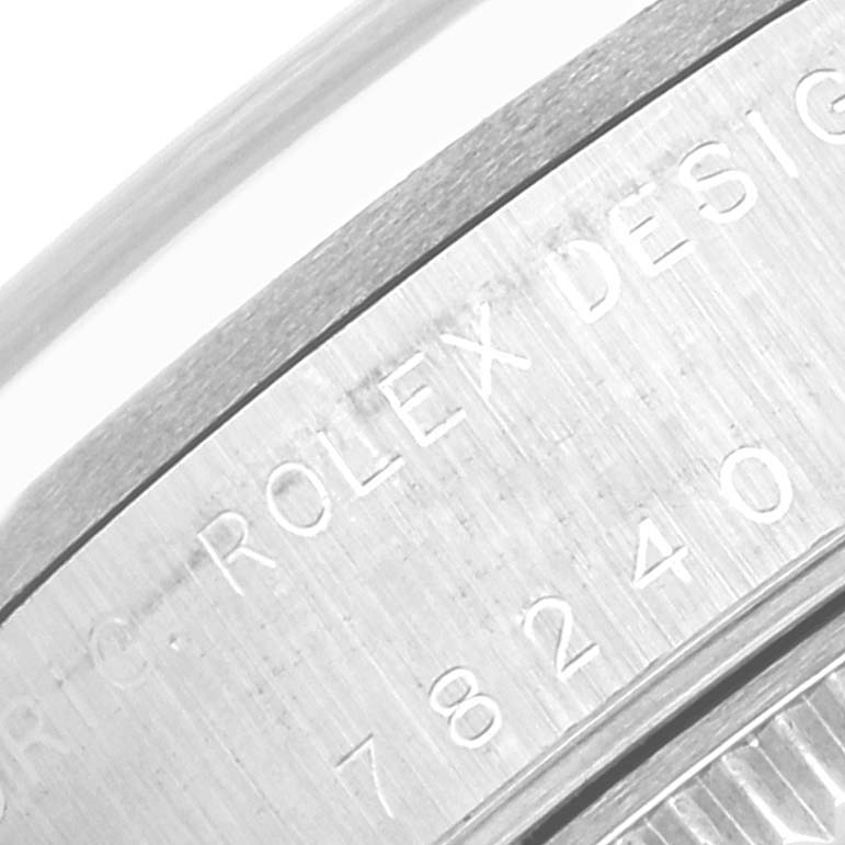 The image shows a close-up of the engraved side of a Rolex Mid-Size 78240 Women's Stainless Steel Pink Dial 78240 Women's Stainless Steel Pink Dial watch, focusing on the model and brand designation.