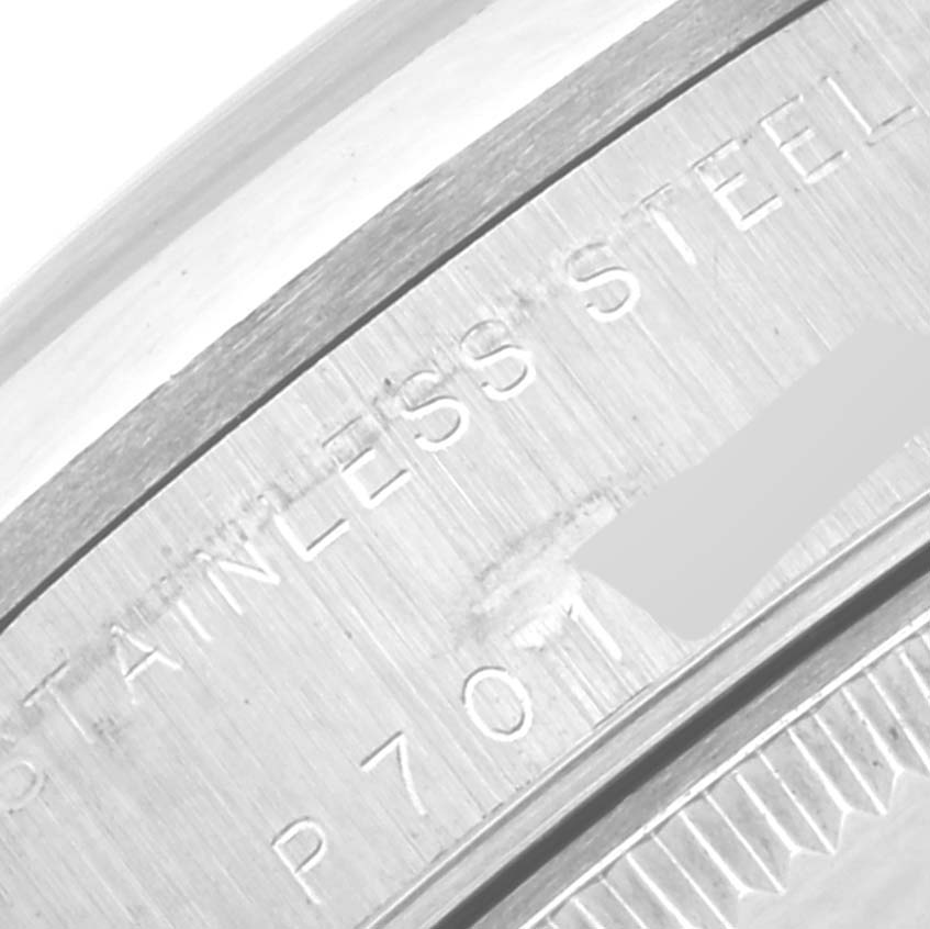 This close-up image shows the side of the stainless steel bezel and case back of a Rolex Mid-Size 78240 Women's Stainless Steel Pink Dial 78240 Women's Stainless Steel Pink Dial model watch.