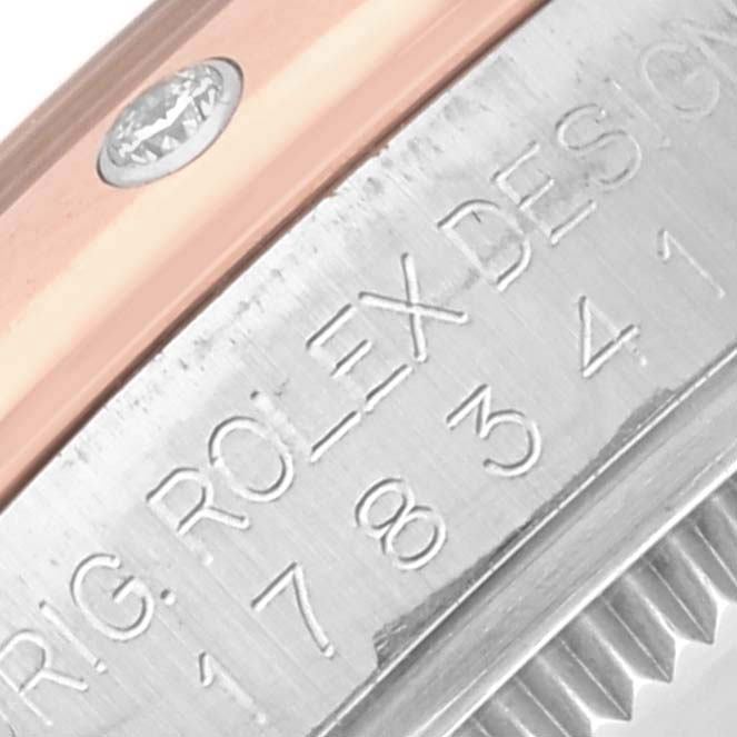 The image shows a close-up of the side detailing on a Rolex Mid-Size 178341 Women's Steel and Gold (two tone) Silver Dial 178341 Women's Steel and Gold (two tone) Silver Dial watch, featuring the engraved bezel and screw component.