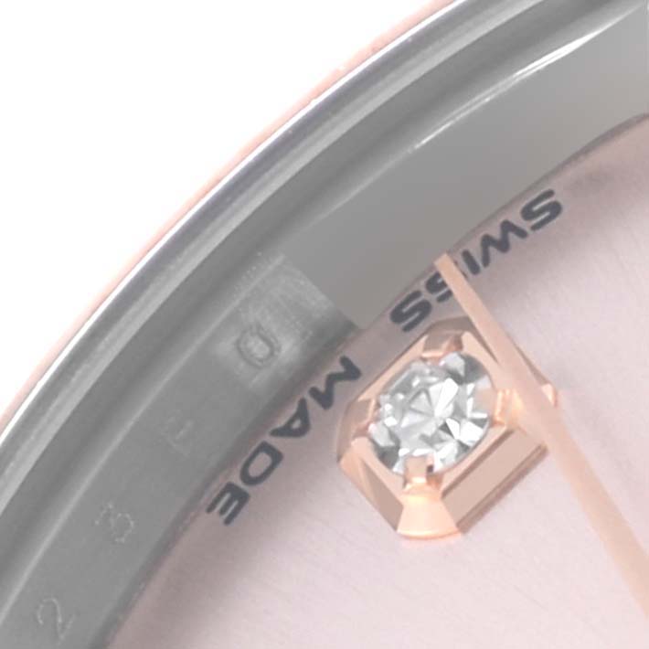 This close-up of a Mid-Size Rolex watch shows the dial edge, a diamond marker, and part of the hand at an oblique angle.