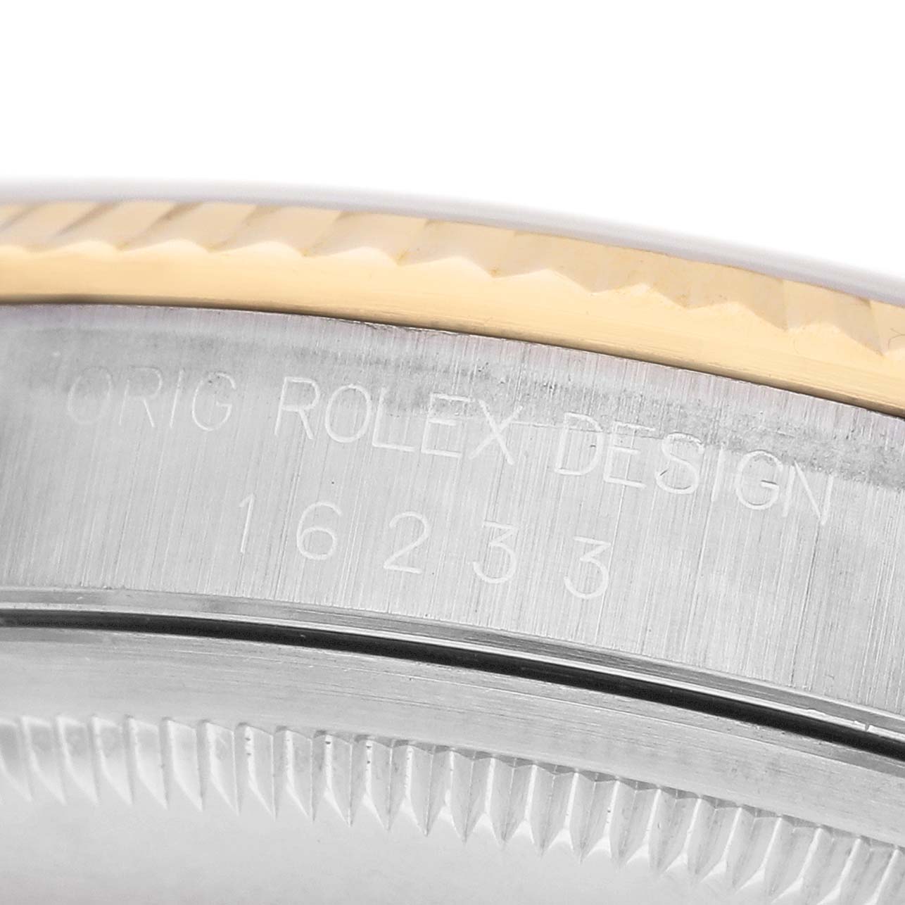 The image shows a close-up of the case edge with engravings and the fluted bezel detail of a Rolex Datejust 16233 Men's Steel and Gold (two tone) White Dial watch.