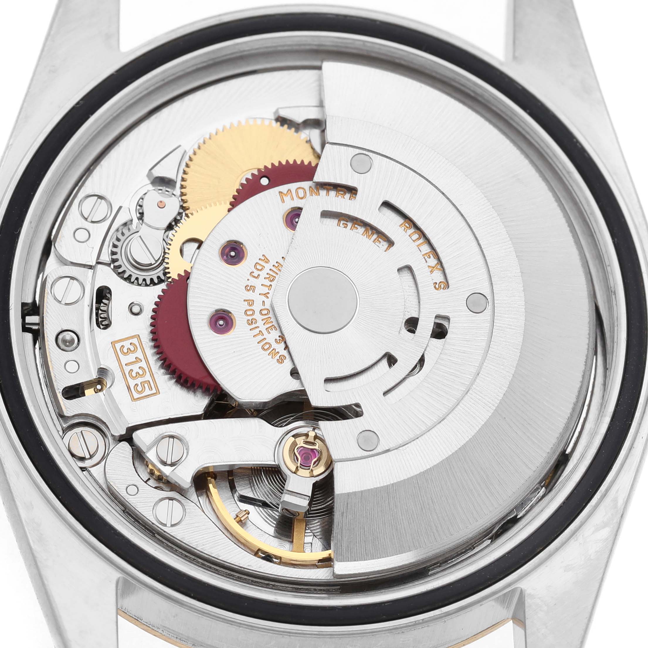 The image shows the movement of a Rolex Datejust 16233 Men's Steel and Gold (two tone) White Dial watch from the back, highlighting gears and the rotor mechanism.