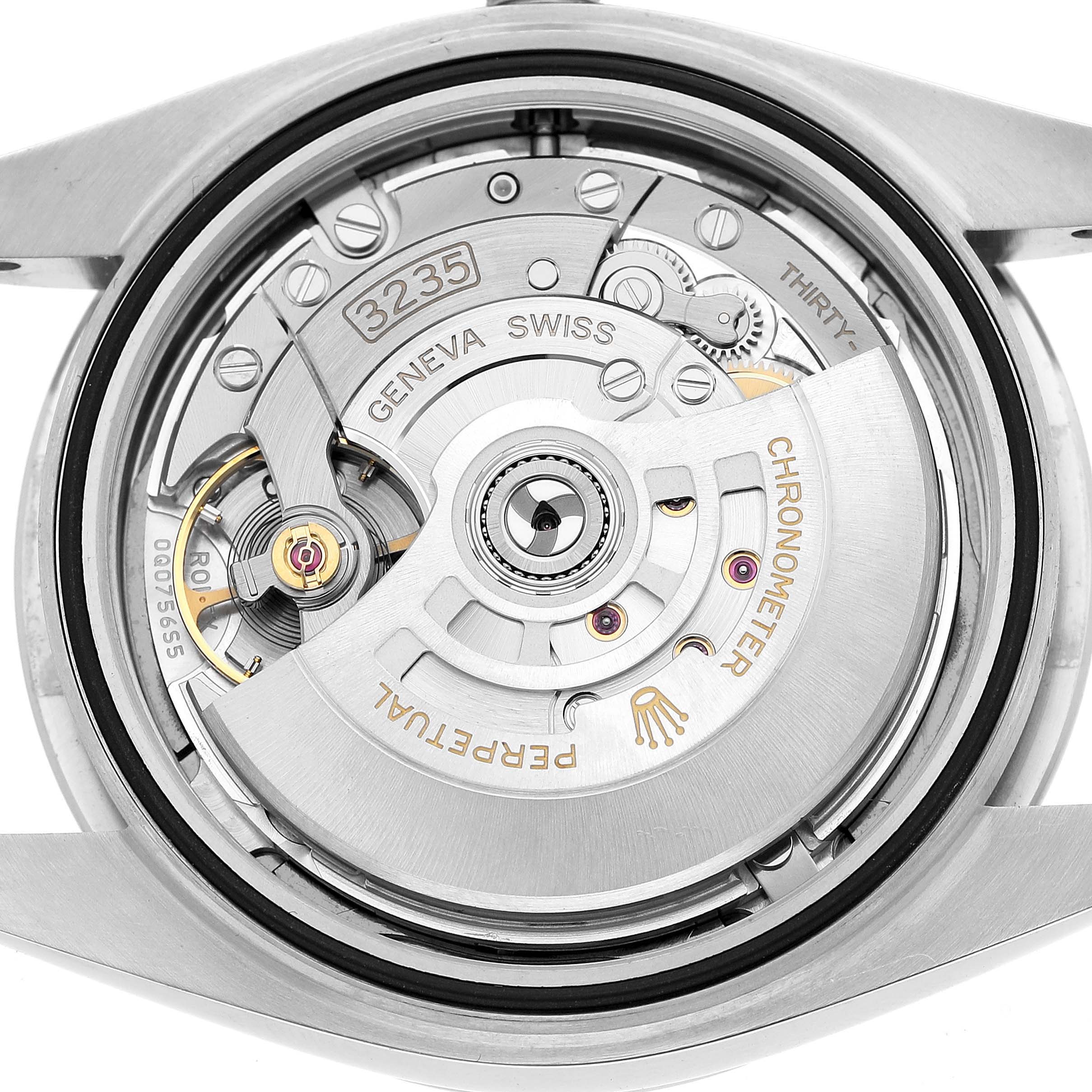 The image shows the Rolex Datejust 126300 Men's Stainless Steel Grey Dial's movement from the back, highlighting the rotor and intricate components.
