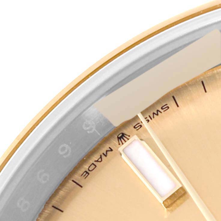 This close-up angle of the Rolex Datejust 41 126303 Men's Steel and Gold (two tone) Champagne Dial 126303 Men's Steel and Gold (two tone) Champagne Dial model shows a portion of the dial, including the edge of the bezel, part of the hour marker, and the Swiss Made text.