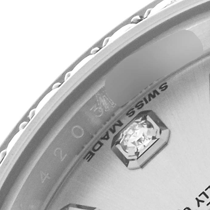 The image shows a close-up of the bezel and part of the dial of a Rolex President 179159 Women's White Gold Silver Dial 179159 Women's White Gold Silver Dial watch, highlighting a diamond marker.