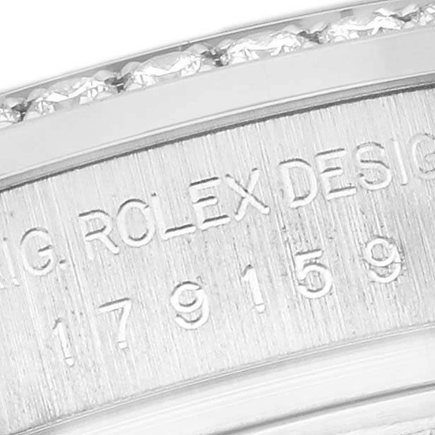 The image shows a close-up of the side engraving on a Rolex President 179159 Women's White Gold Silver Dial 179159 Women's White Gold Silver Dial model watch, highlighting the serial numbers.