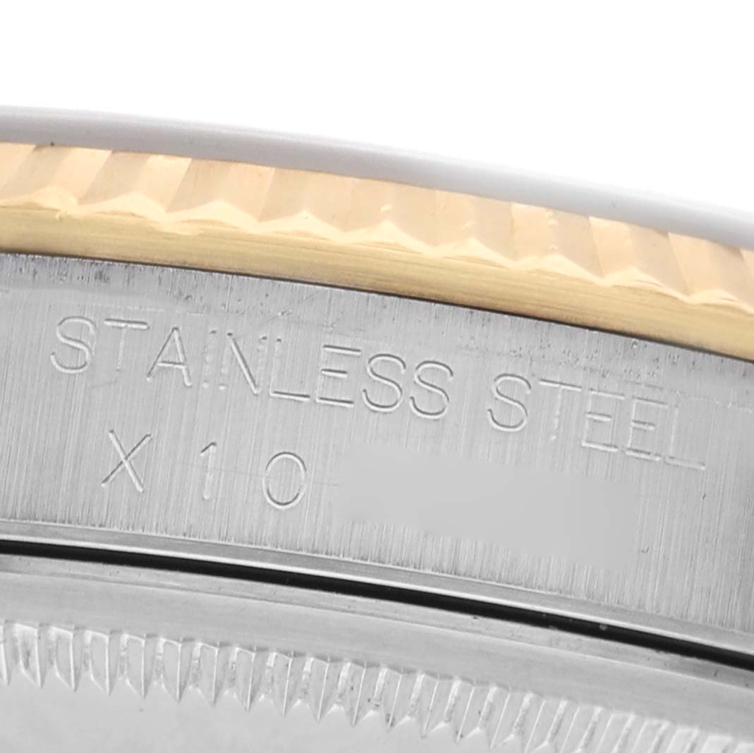The image shows a close-up of the Rolex Datejust 16233 Men's Steel and Gold (two tone) Silver Dial's bezel and engraved case edge.