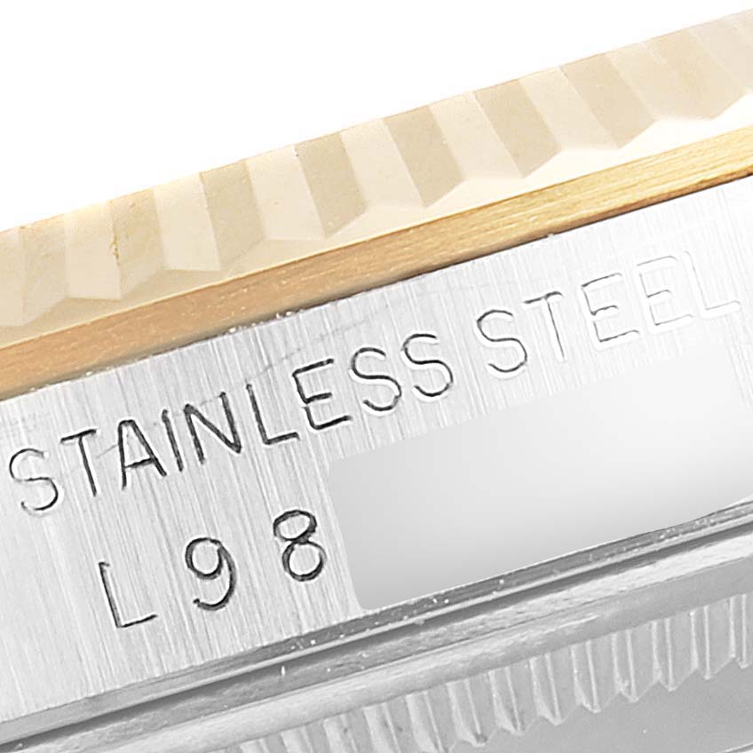 This image shows a close-up of the bezel and casing of a Rolex Datejust 16233 Men's Steel and Gold (two tone) Black Dial 16233 Men's Steel and Gold (two tone) Black Dial watch, highlighting the "STAINLESS STEEL" engraving.