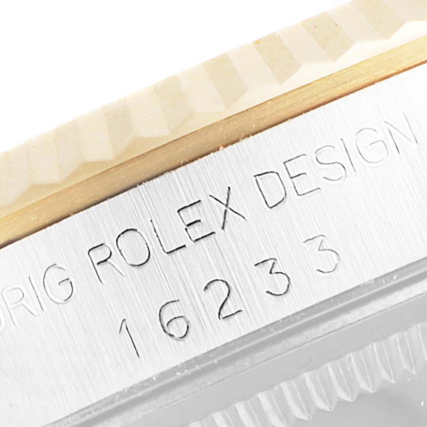 This close-up image shows the edge of the bezel and the engraved serial number on a Rolex Datejust 16233 Men's Steel and Gold (two tone) Black Dial 16233 Men's Steel and Gold (two tone) Black Dial watch.