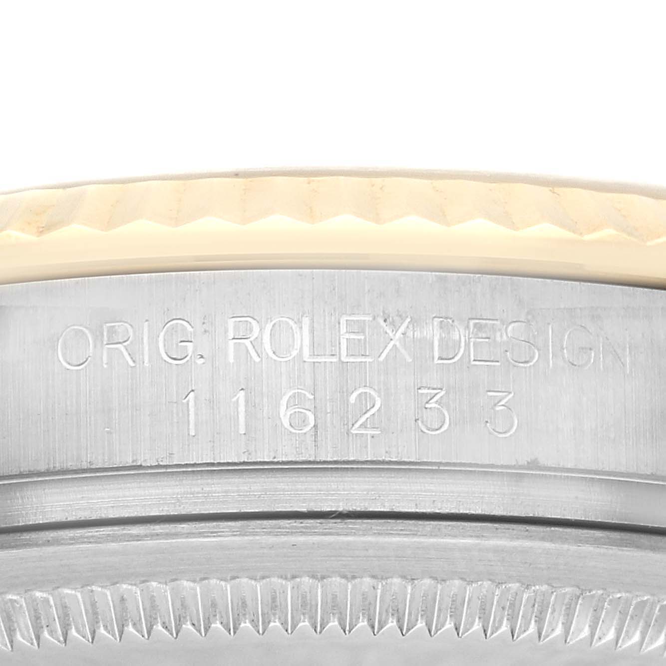 The image shows a close-up of the bezel and part of the case with engravings on a Rolex Datejust 116233 Men's Steel and Gold (two tone) Champagne Dial 116233 Men's Steel and Gold (two tone) Champagne Dial watch.