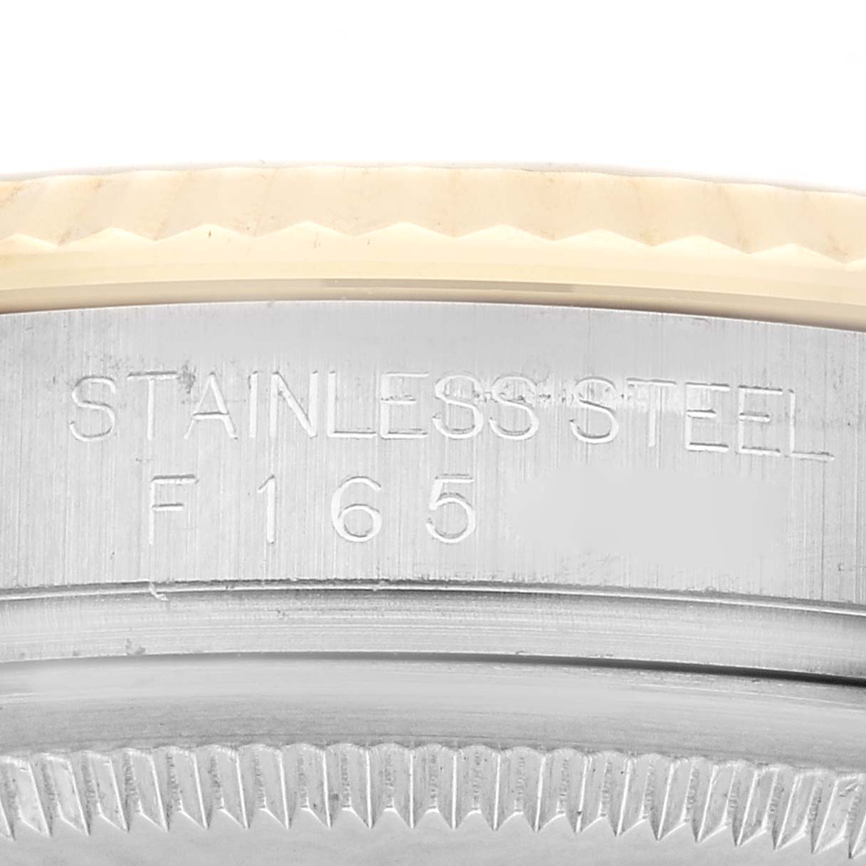 This image shows the side profile of the bezel and part of the case of a Rolex Datejust 116233 Men's Steel and Gold (two tone) Champagne Dial 116233 Men's Steel and Gold (two tone) Champagne Dial, highlighting the stainless steel marking.