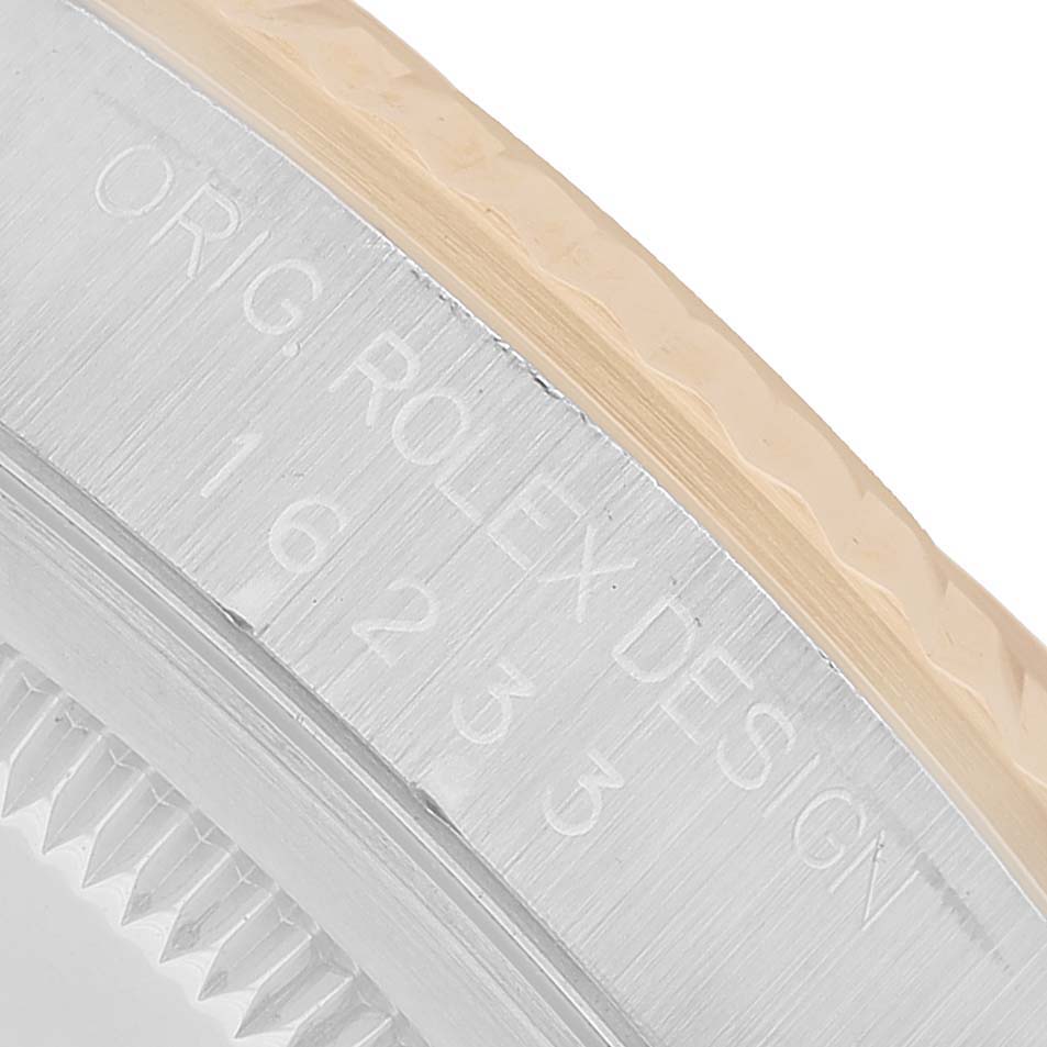 The image shows a close-up of the side of a Rolex Datejust 16233 Men's Steel and Gold (two tone) Champagne Dial watch case with engraved model details.