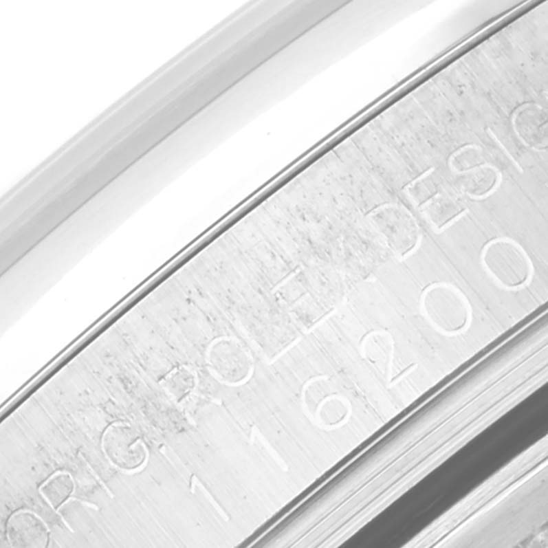 The image shows an angled close-up of the serial engraving on the bezel of a Rolex Datejust 116200 Men's Stainless Steel White Dial 116200 Men's Stainless Steel White Dial watch.