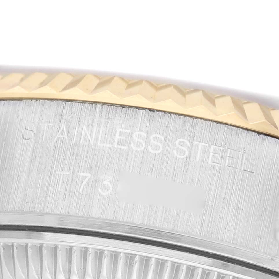 The image shows a close-up of the bezel and case side of the Rolex Datejust 69173 Women's Steel and Gold (two tone) White Dial, highlighting the fluted bezel and "Stainless Steel" engraving.