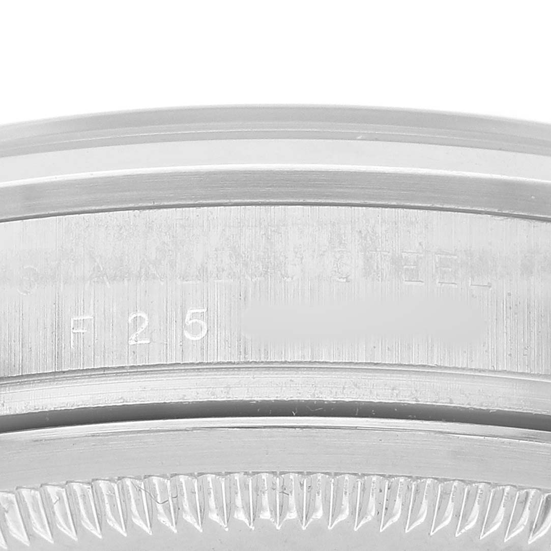 The image shows a close-up of the side of a Rolex Explorer 114270 Men's Stainless Steel Black Dial watch case, focusing on the engraved details.