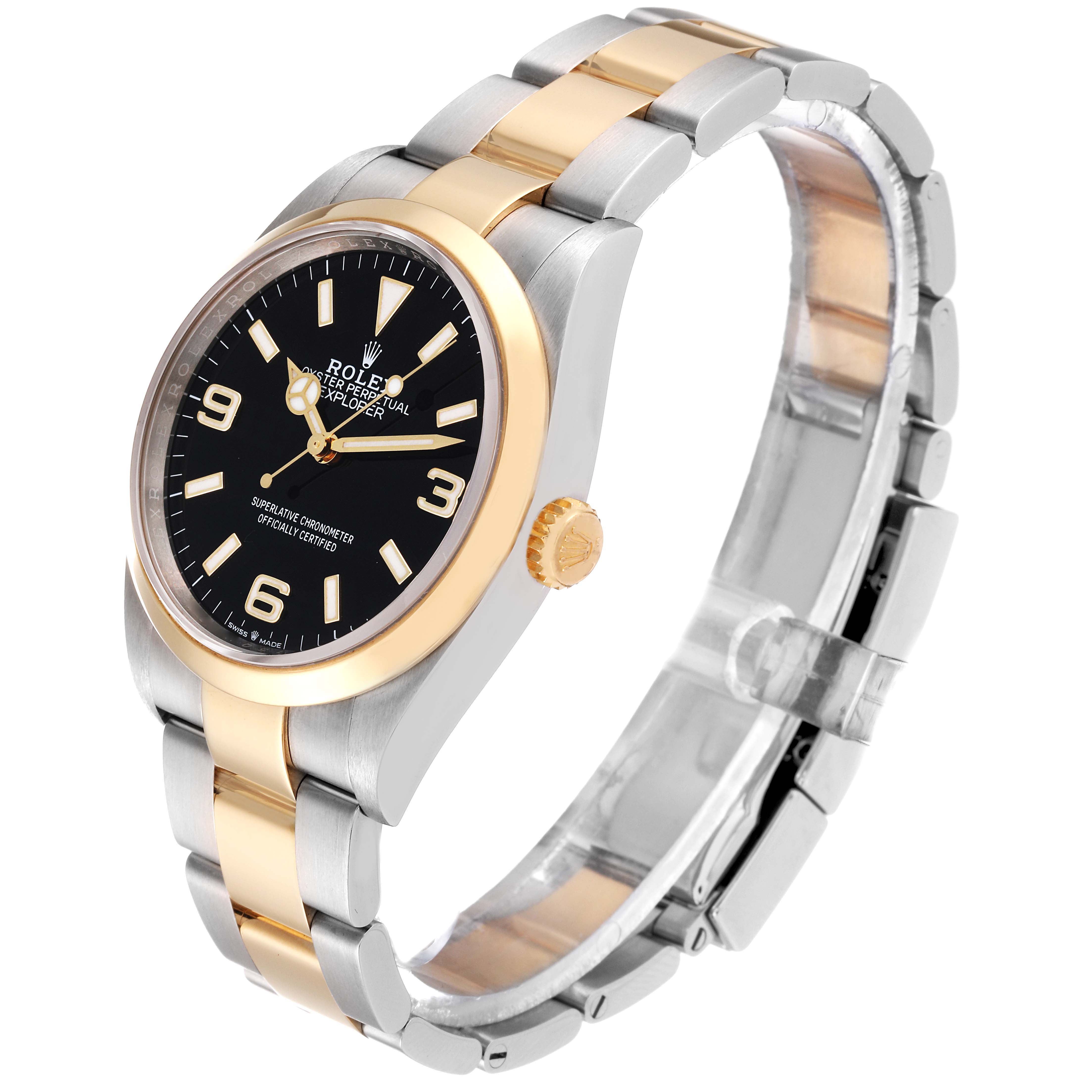 The Rolex Explorer 124273 Men
s Steel and Gold (two tone) Black Dial 124273 Men
s Steel and Gold (two tone) Black Dial watch is shown at a slight angle revealing its black dial, gold bezel, crown, and two-tone link bracelet.