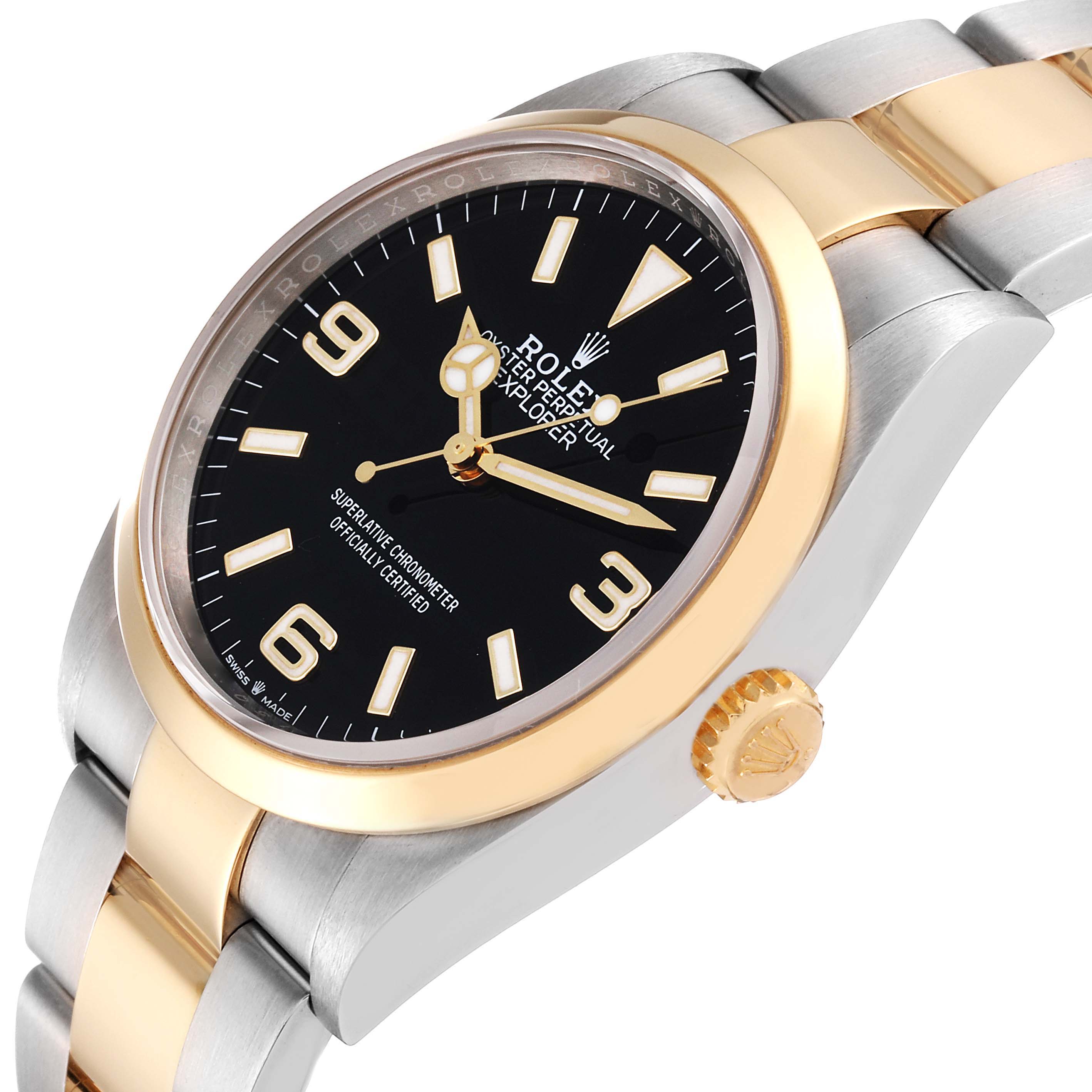 The Rolex Explorer 124273 Men
s Steel and Gold (two tone) Black Dial 124273 Men
s Steel and Gold (two tone) Black Dial watch is shown from an angled side view, highlighting its black dial, gold bezel, and two-tone bracelet.