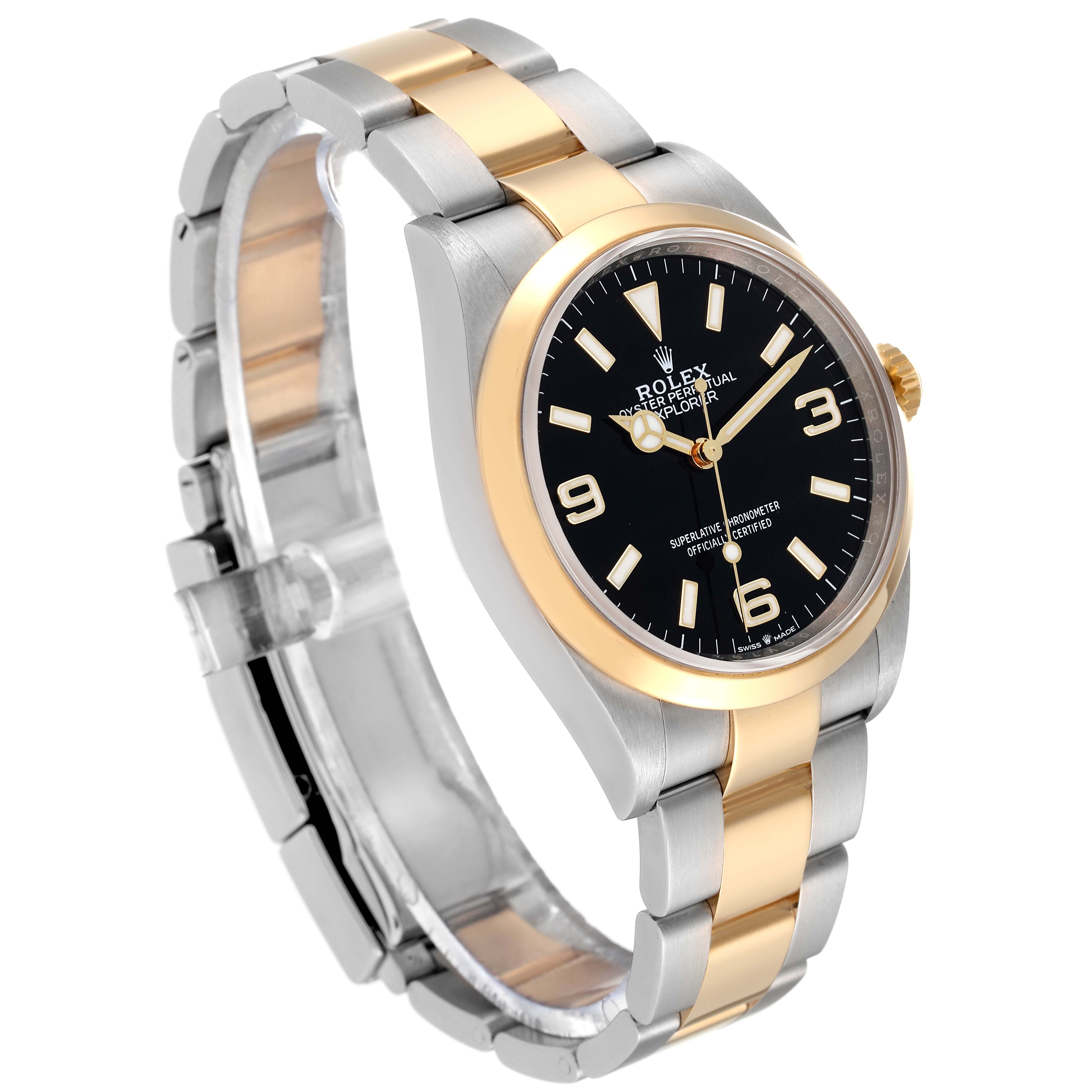 This image shows a Rolex Explorer 124273 Men
s Steel and Gold (two tone) Black Dial 124273 Men
s Steel and Gold (two tone) Black Dial watch from a three-quarter angle, highlighting its dial, bezel, and two-tone bracelet.