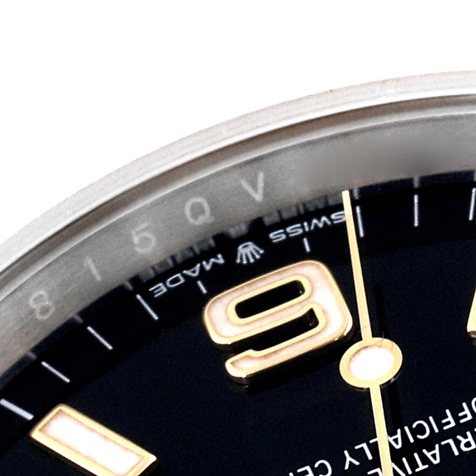 The image shows a close-up angle of the Rolex Explorer 124273 Men
s Steel and Gold (two tone) Black Dial 124273 Men
s Steel and Gold (two tone) Black Dial watch, focusing on the dial, bezel, and part of the hands.