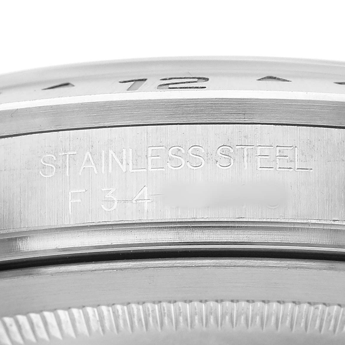 The image shows a close-up side angle of the Rolex Explorer 16570 Men's Stainless Steel White Dial's stainless steel case detailing.