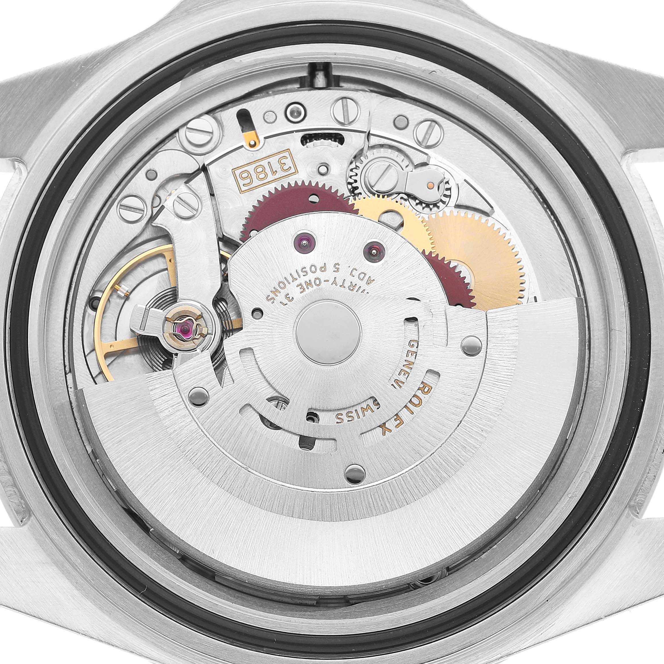 The image shows a close-up of the movement inside a Rolex Explorer 16570 Men's Stainless Steel White Dial watch, highlighting gears and mechanisms.