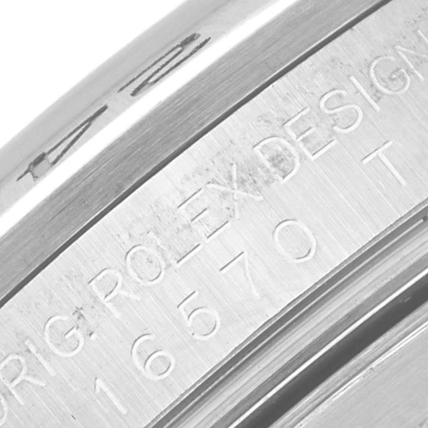 This image shows an angled close-up of the engraved bezel and case back of a Rolex Explorer 16570 Men
s Stainless Steel White Dial 16570 Men
s Stainless Steel White Dial model watch.