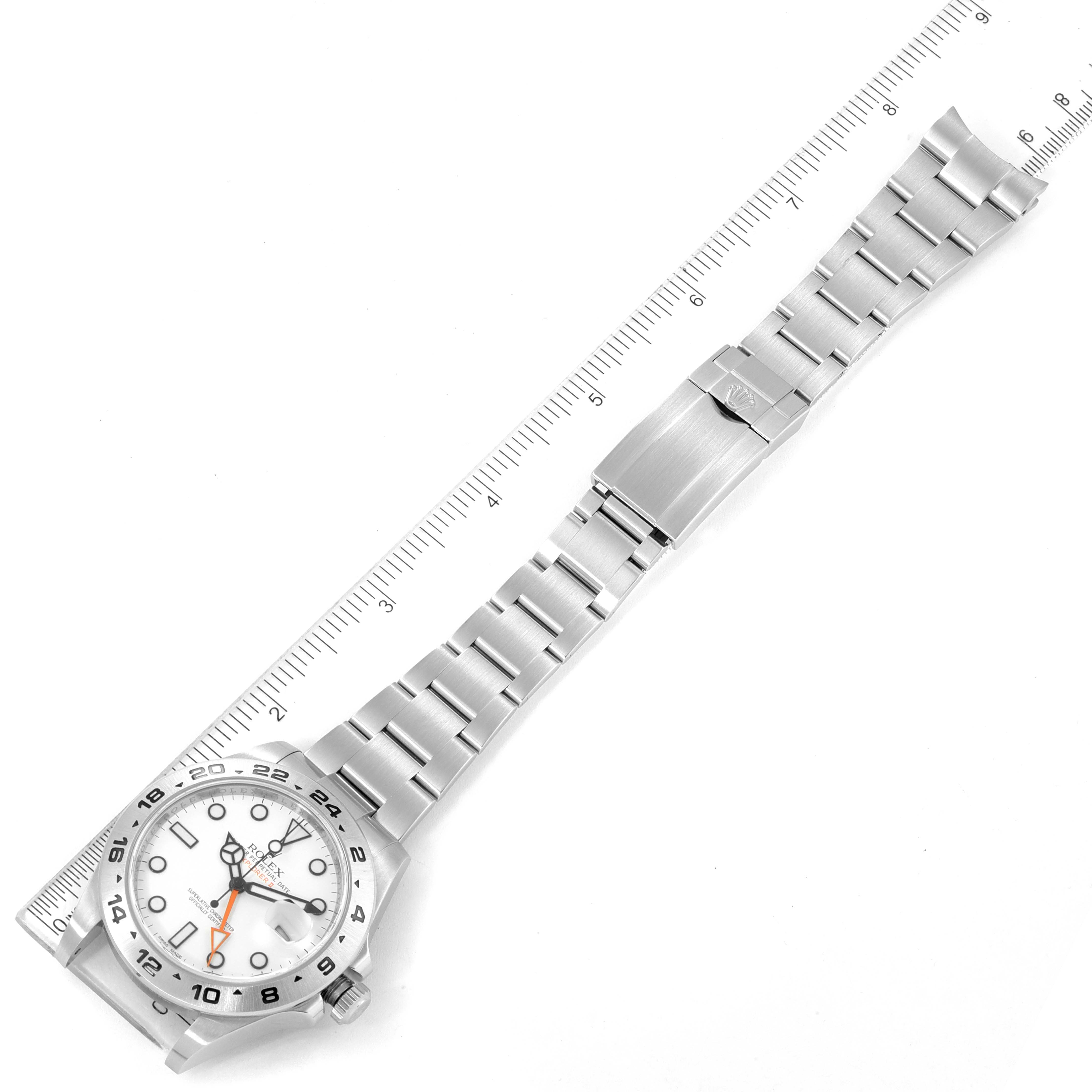 The image shows a top-down view of a Rolex Explorer 216570 Men's Stainless Steel White Dial 216570 Men's Stainless Steel White Dial watch, displaying the face, band, and clasp, aligned with a ruler.