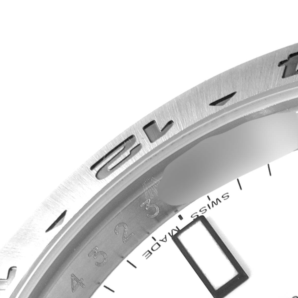 This close-up image shows part of the bezel and dial of the Rolex Explorer 216570 Men's Stainless Steel White Dial 216570 Men's Stainless Steel White Dial watch.