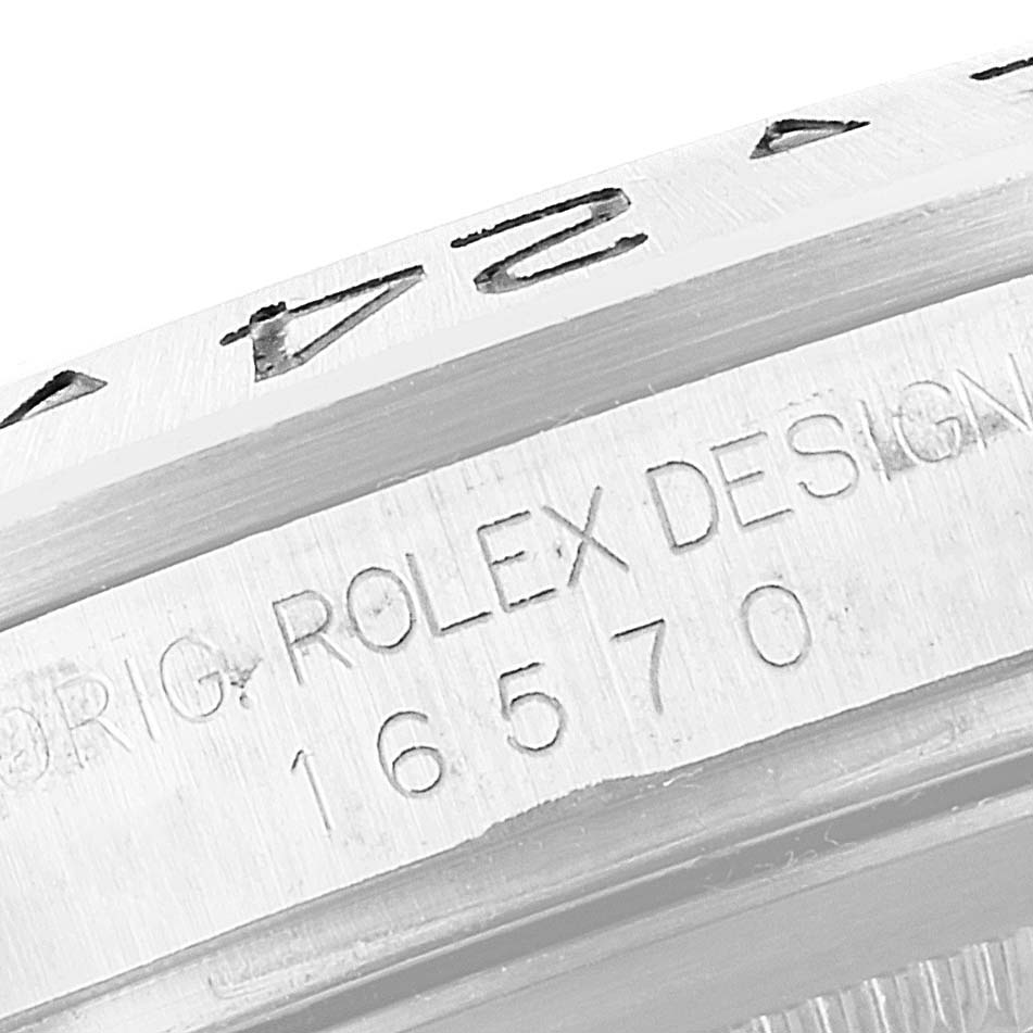 The image shows a close-up of the bezel and engraved serial number of a Rolex Explorer 16570 Men
s Stainless Steel Black Dial 16570 Men
s Stainless Steel Black Dial model watch.