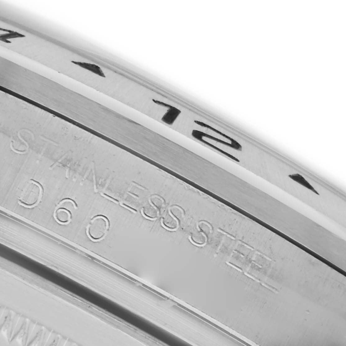 The image shows a close-up of the Rolex Explorer 16570 Men's Stainless Steel Black Dial 16570 Men's Stainless Steel Black Dial's stainless steel bezel edge with engraved numbers and text.