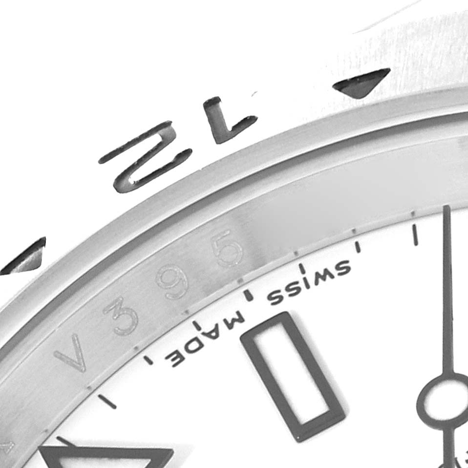 The image shows a close-up of the dial and bezel of a Rolex Explorer 16570T Men
s Stainless Steel White Dial 16570T Men
s Stainless Steel White Dial watch, highlighting the numerals and 
Swiss Made
 text.