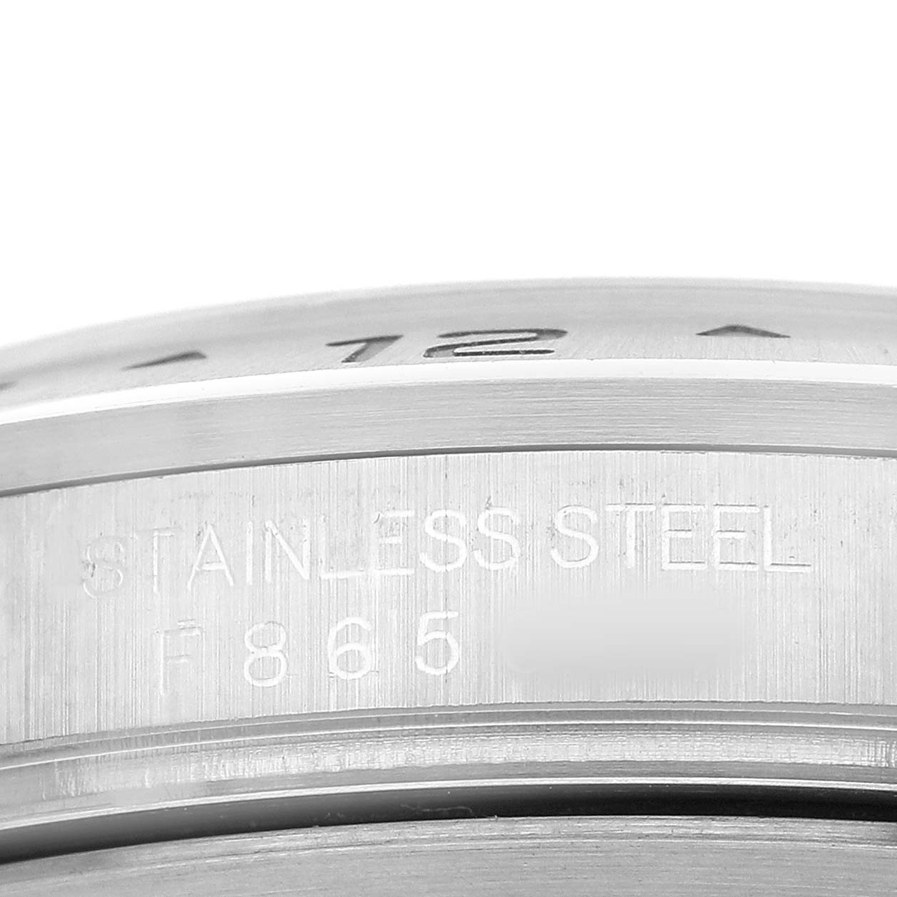 The image shows a close-up of the stainless steel casing with engravings on a Rolex Explorer 16570 Men's Stainless Steel Black Dial watch.
