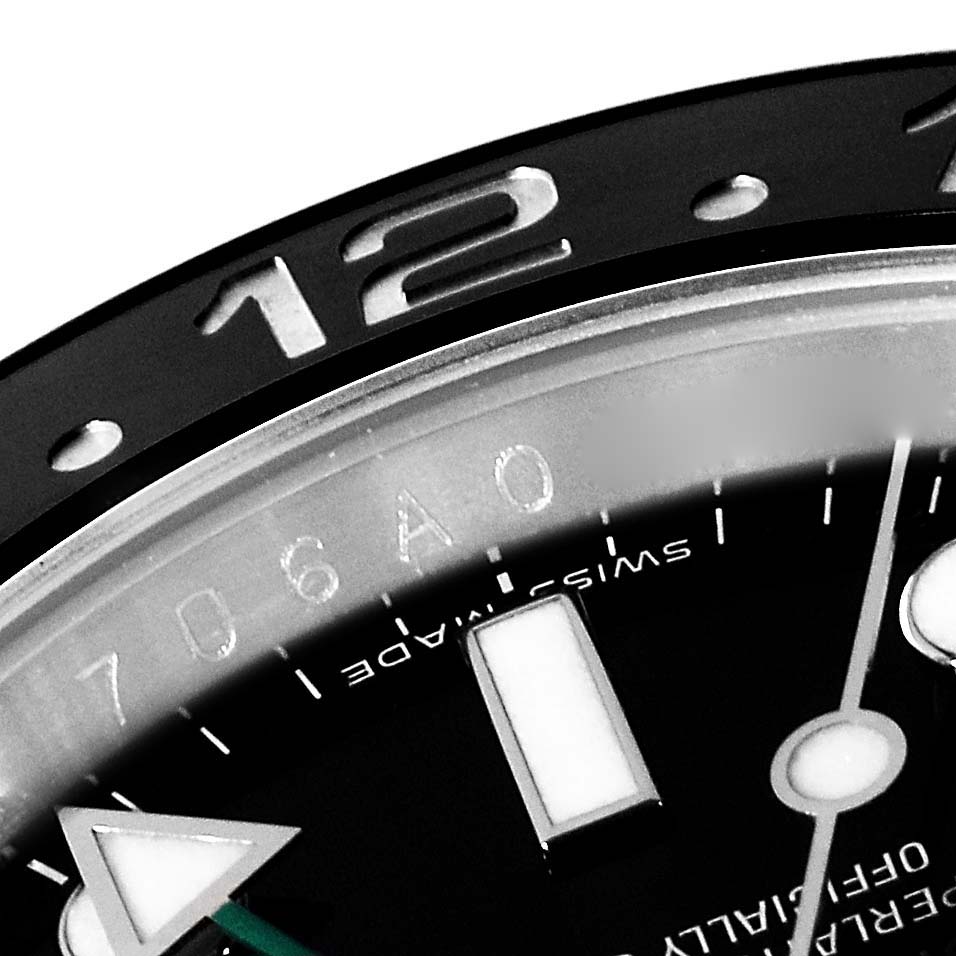 The image shows a close-up of the 12 o'clock marker and part of the dial on a Rolex GMT-Master 116710LN Men's Stainless Steel Black Dial 116710LN Men's Stainless Steel Black Dial watch.