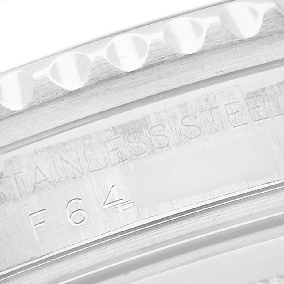 This image shows a close-up of the Rolex GMT-Master 16710 Men
s Stainless Steel Black Dial 16710 Men
s Stainless Steel Black Dial
s stainless steel bezel with engraved details.