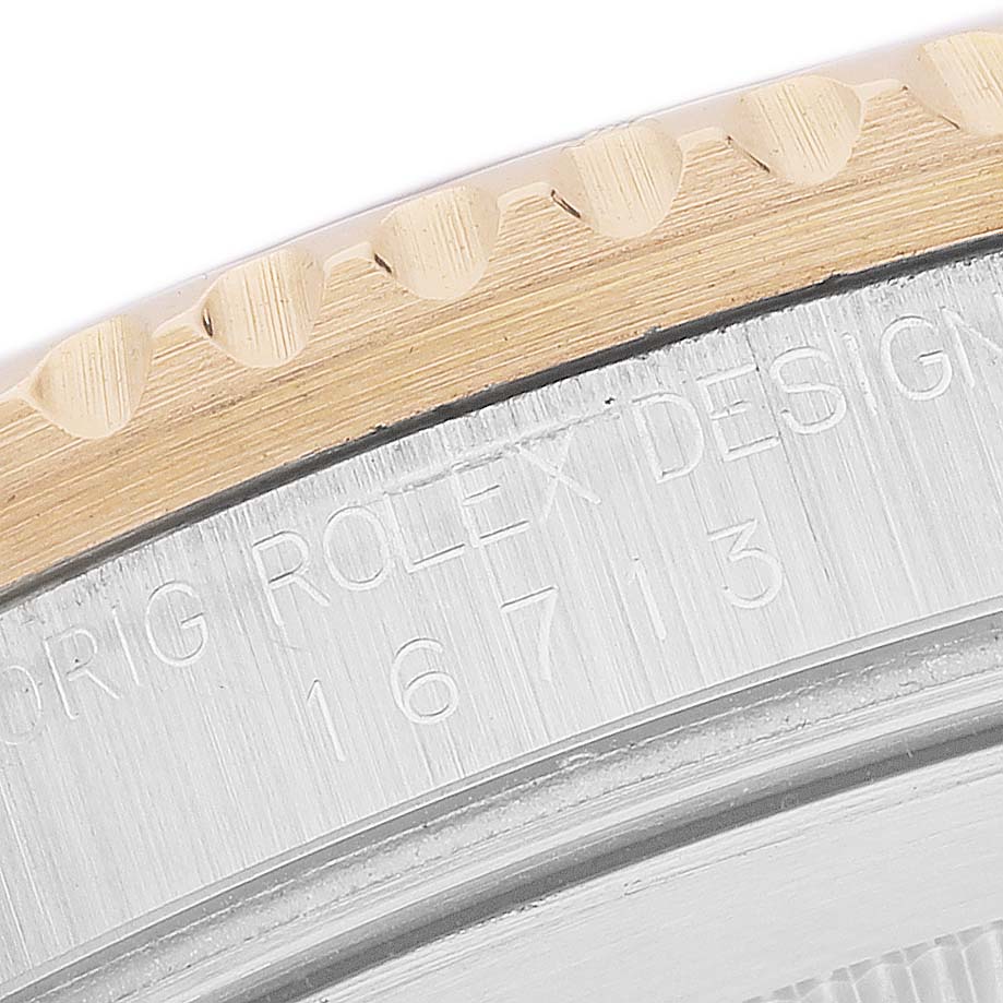 The image shows a close-up of the case side and bezel edge of a Rolex GMT-Master 16713 Men's Steel and Gold (two tone) Brown Dial.