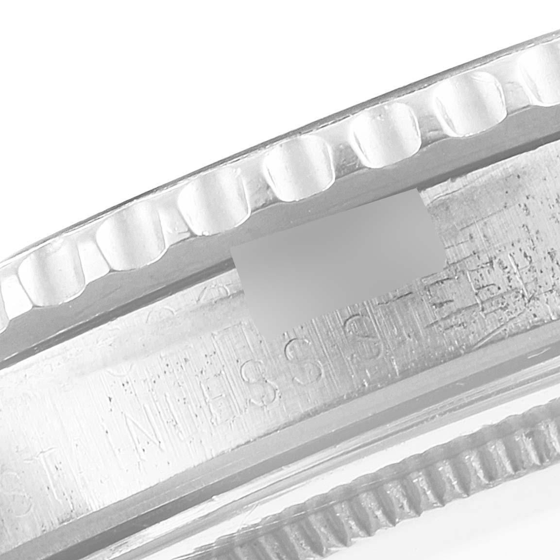 This image shows a close-up of the bezel and case of the Rolex GMT-Master 1675 Men's Stainless Steel Black Dial 1675 Men's Stainless Steel Black Dial watch, highlighting the stainless steel stamp.