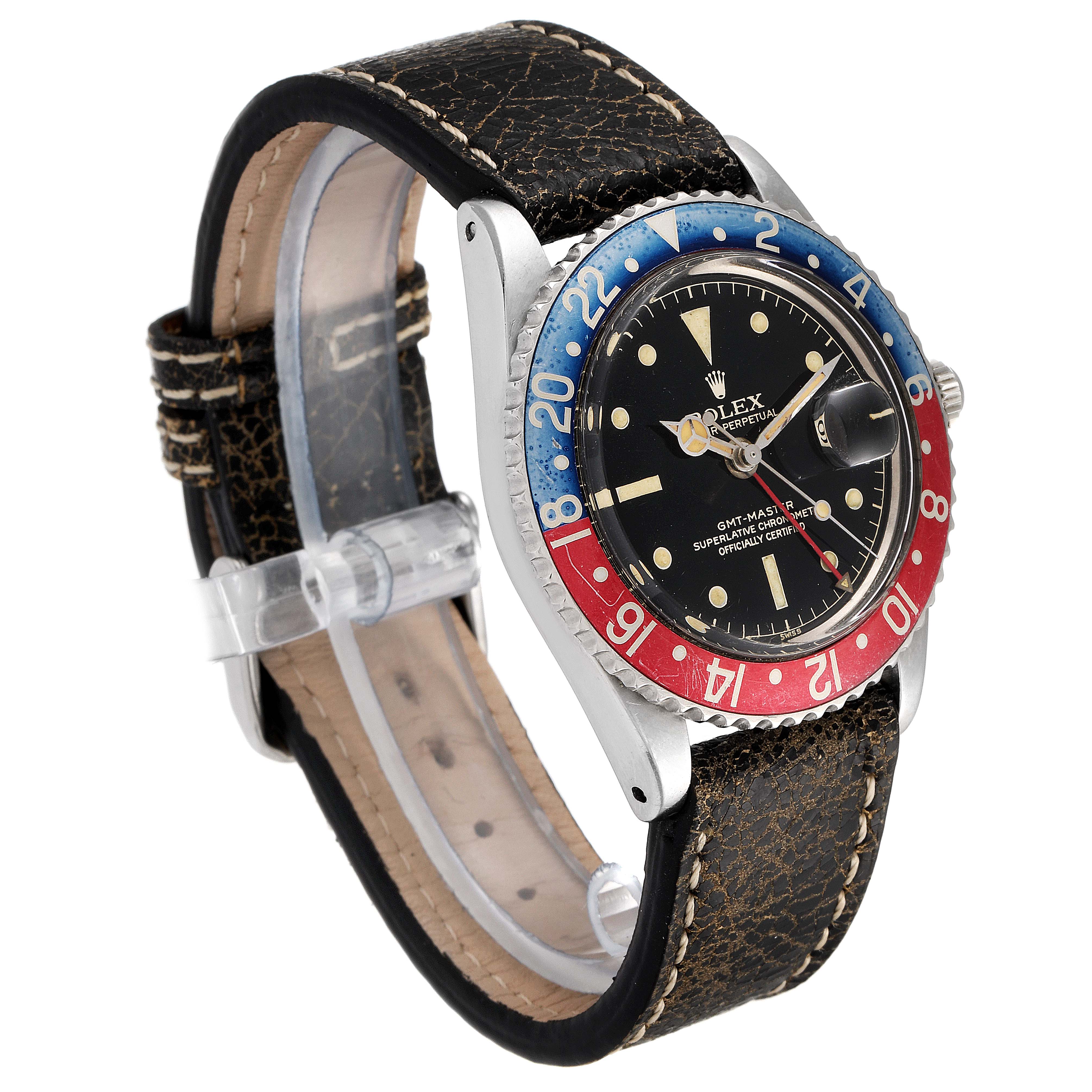 The Rolex GMT-Master 1675 Men's Stainless Steel Black Dial 1675 Men's Stainless Steel Black Dial watch is displayed at a slight side angle, showing the face, bezel, case, and worn leather strap.