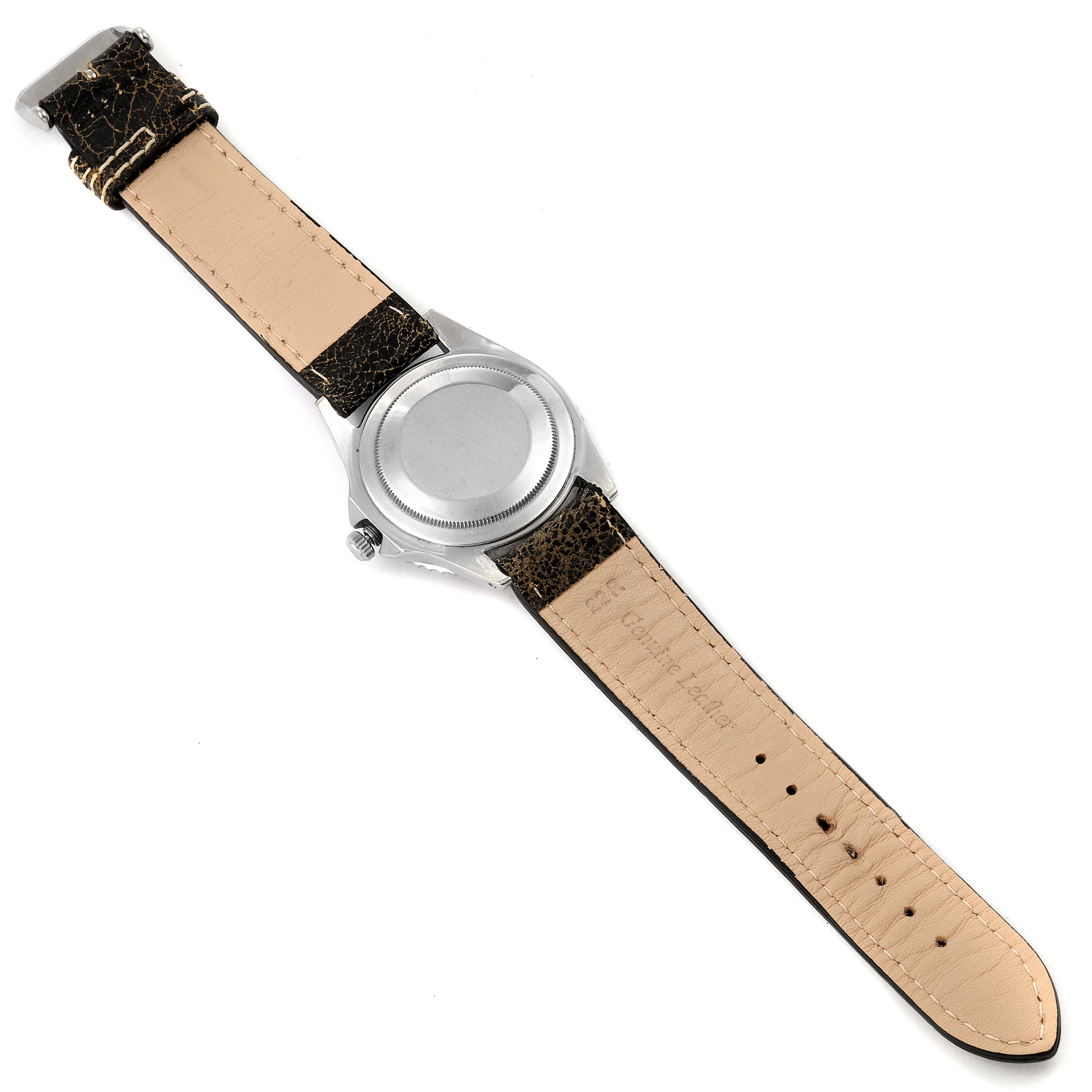 The image shows the back view of a Rolex GMT-Master 1675 Men's Stainless Steel Black Dial 1675 Men's Stainless Steel Black Dial watch with its leather strap laid flat.