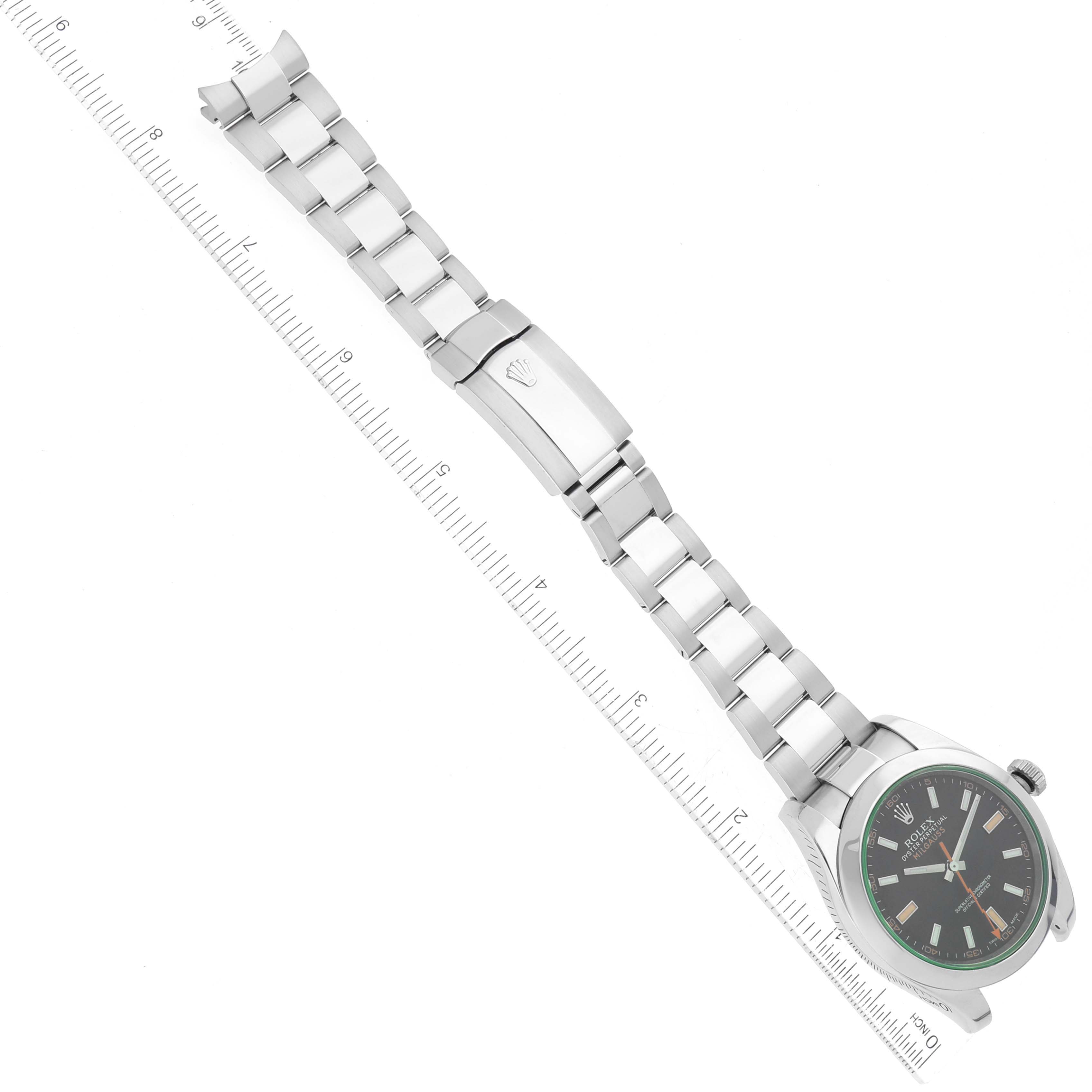 The image shows a top-down view of a Rolex Milgauss 116400GV Men's Stainless Steel Black Dial 116400GV Men's Stainless Steel Black Dial watch with its full bracelet extended and a ruler for scale.