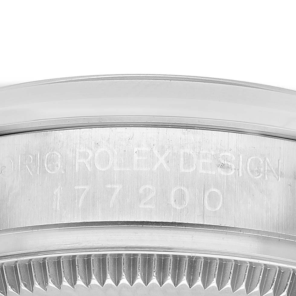 The image shows a close-up of the side of a Rolex Oyster Perpetual 177200 Women's Stainless Steel Purple Dial watch case, highlighting the engravings.