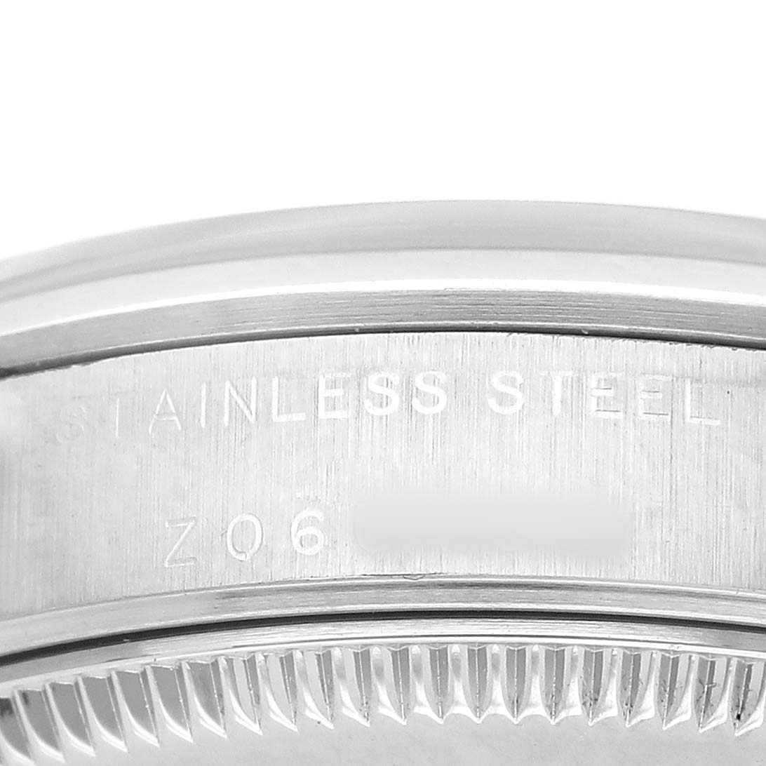 The image shows a close-up of the side of a Rolex Oyster Perpetual 77080 Women's Stainless Steel Pink Dial watch, highlighting the stainless steel engraving.