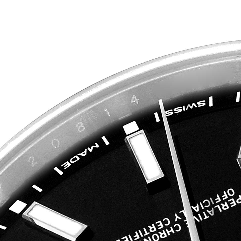 This image shows a close-up view of the dial and hands of a Rolex Oyster Perpetual 114300 Men
s Stainless Steel Black Dial 114300 Men
s Stainless Steel Black Dial watch.