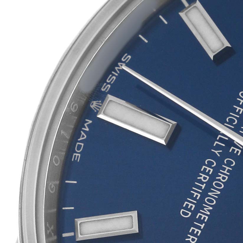 The image shows a close-up of the dial and bezel of a Rolex Oyster Perpetual 277200 Women's Stainless Steel Blue Dial watch, highlighting the hour markers and part of the minute hand.