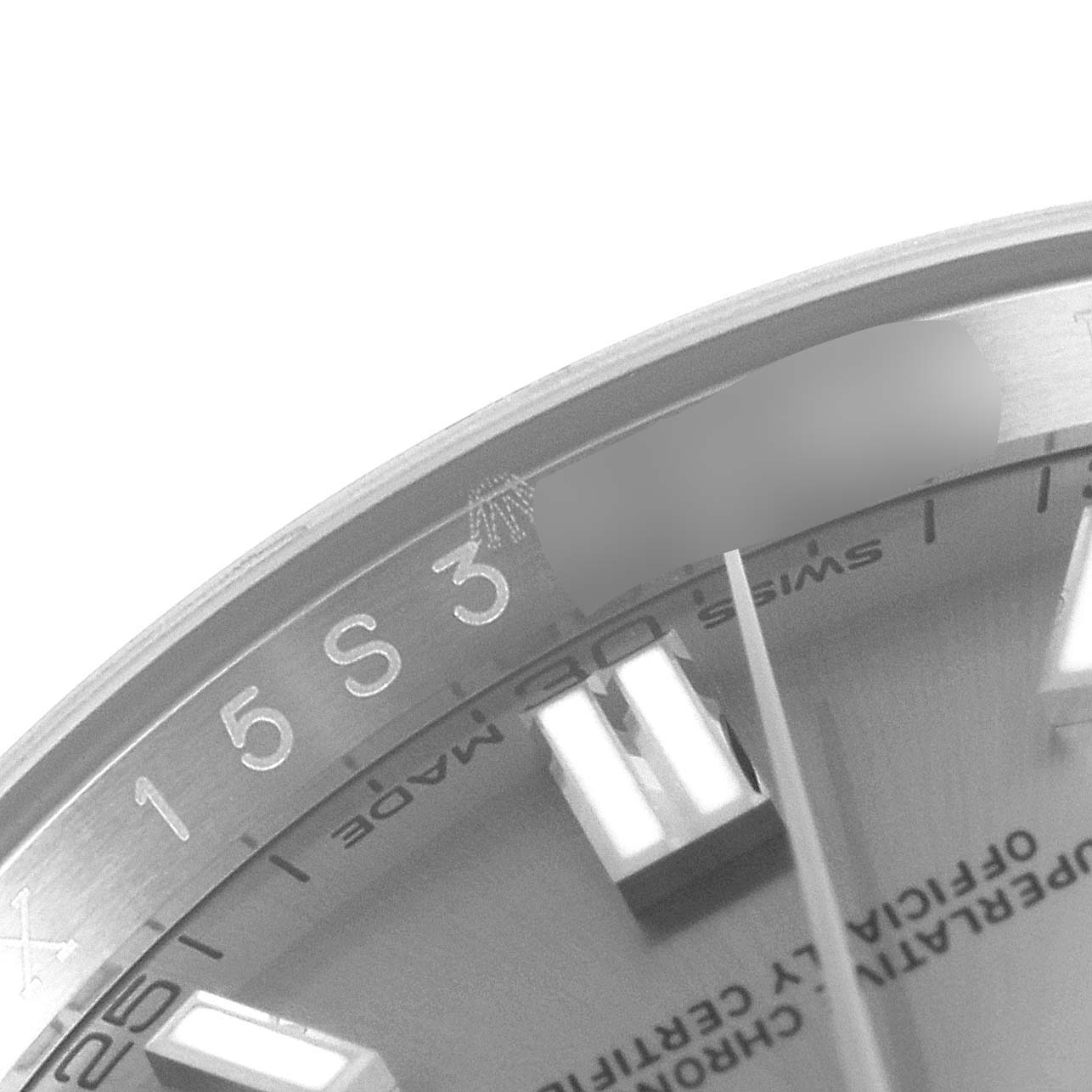 This image shows a close-up of the dial and a part of the bezel of the Rolex Oyster Perpetual 116000 Men's Stainless Steel Grey Dial 116000 Men's Stainless Steel Grey Dial watch, highlighting the hour markers and text details.