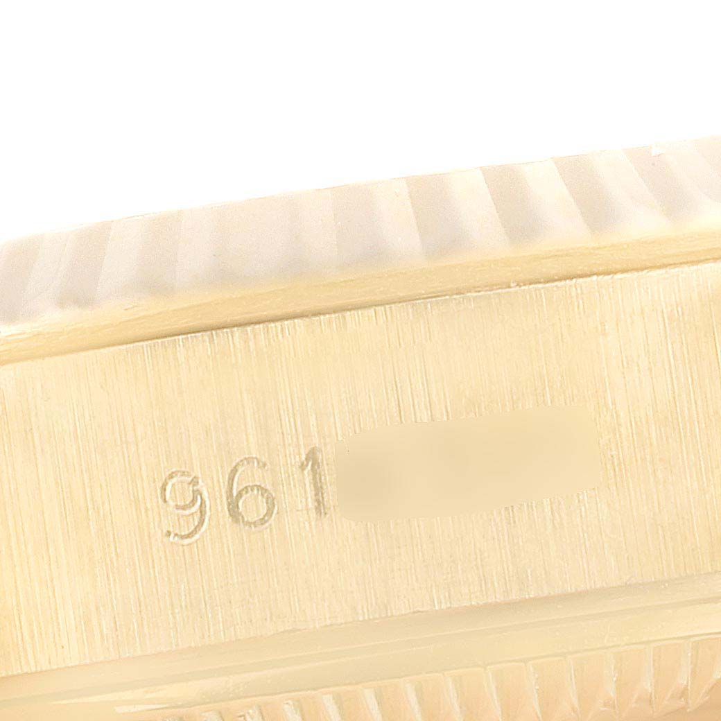 This close-up image shows the side of the Rolex President 69178 Women's Yellow Gold Champagne Dial 69178 Women's Yellow Gold Champagne Dial watch case with part of its serial number engraved.