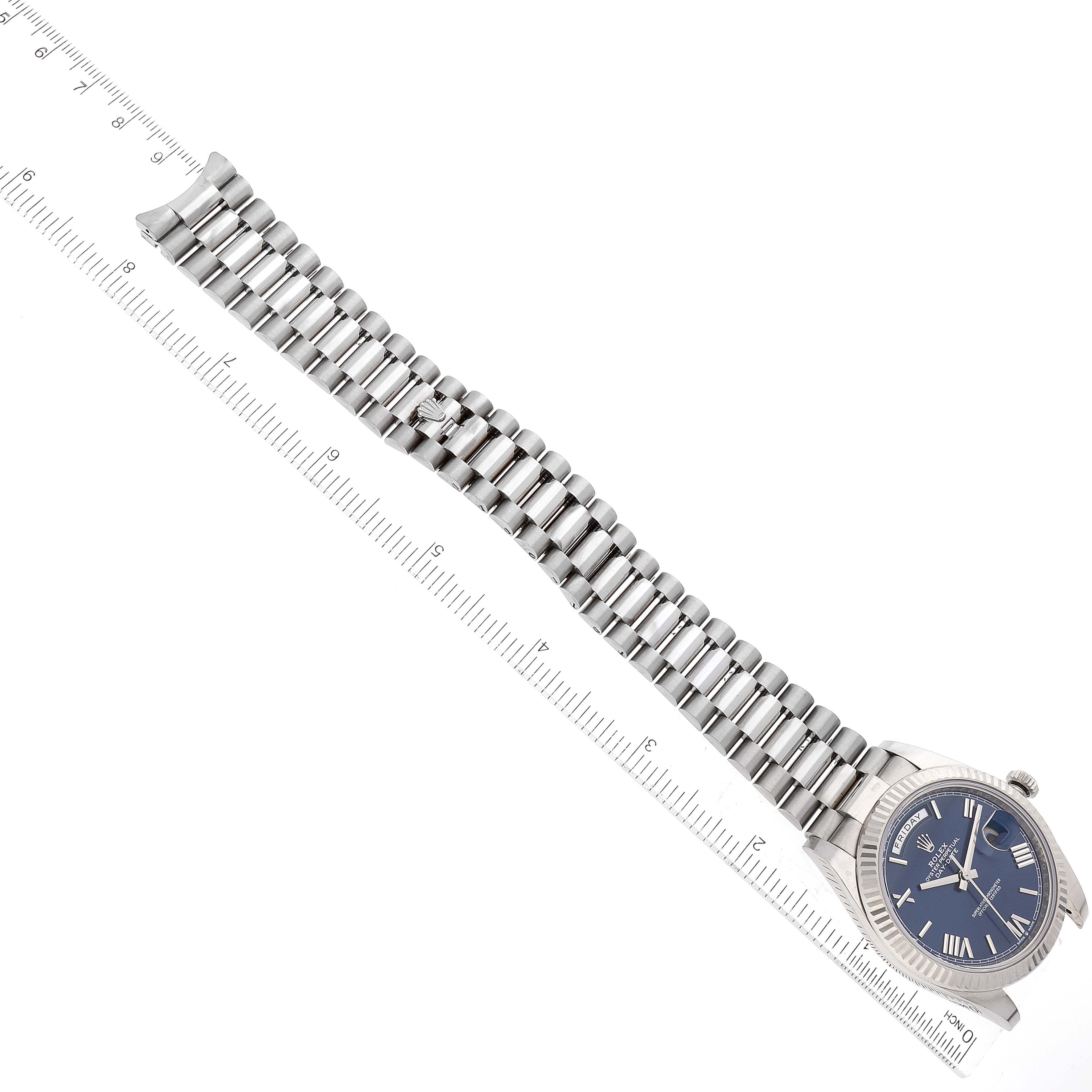 The image shows the full length of a Rolex President 228239 Men's White Gold Blue Dial 228239 Men's White Gold Blue Dial model watch, laid flat beside a ruler.