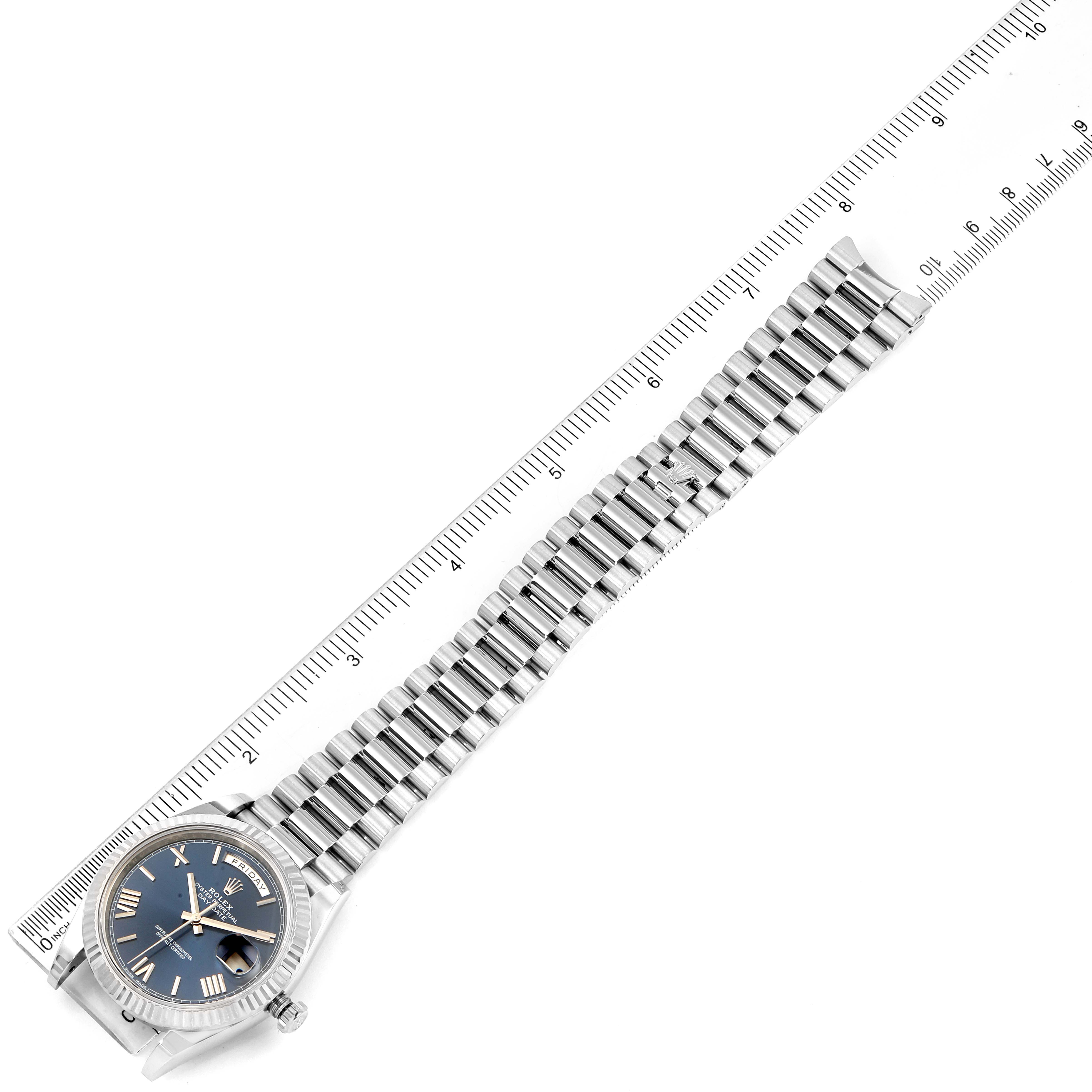 The image shows the full face and bracelet of a Rolex President 228239 Men's White Gold Blue Dial 228239 Men's White Gold Blue Dial model watch laid next to a ruler for measurement.