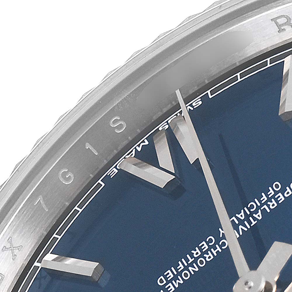 This image shows a close-up of the dial and bezel of a Rolex President 228239 Men's White Gold Blue Dial 228239 Men's White Gold Blue Dial model watch, highlighting the hour markers and minute hand.