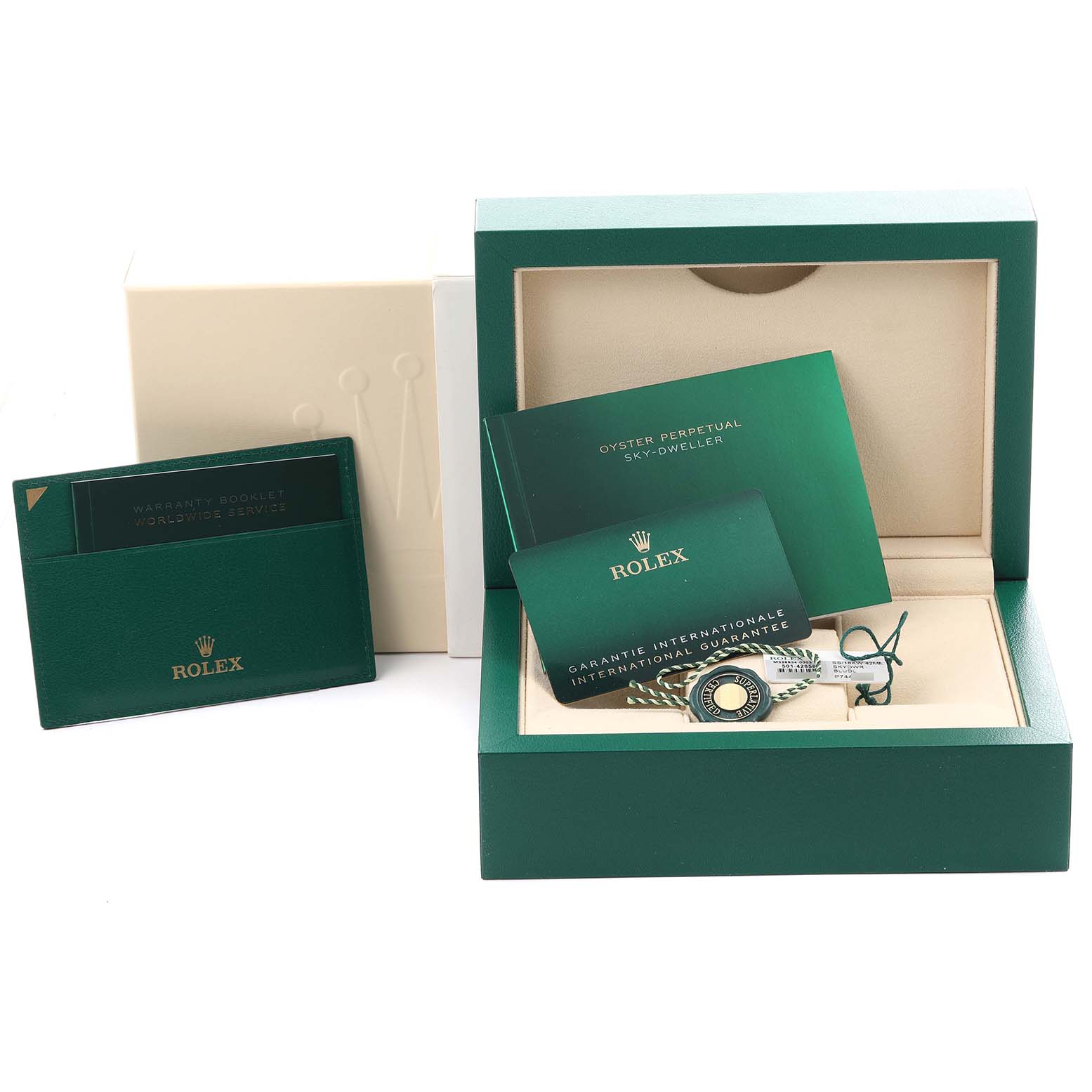 The image shows a Rolex Sky-Dweller 326934 Men's Stainless Steel Blue Dial 326934 Men's Stainless Steel Blue Dial box set with booklets, cards, and a tag in a green presentation box.